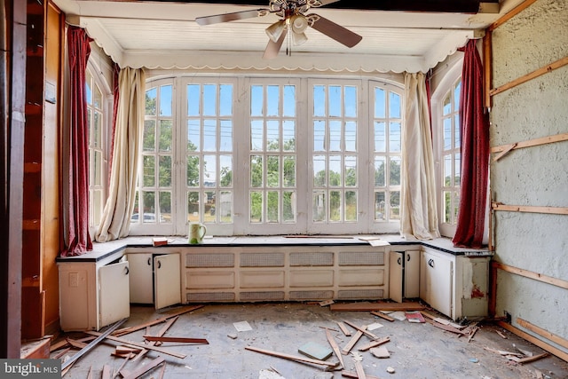 unfurnished sunroom with ceiling fan