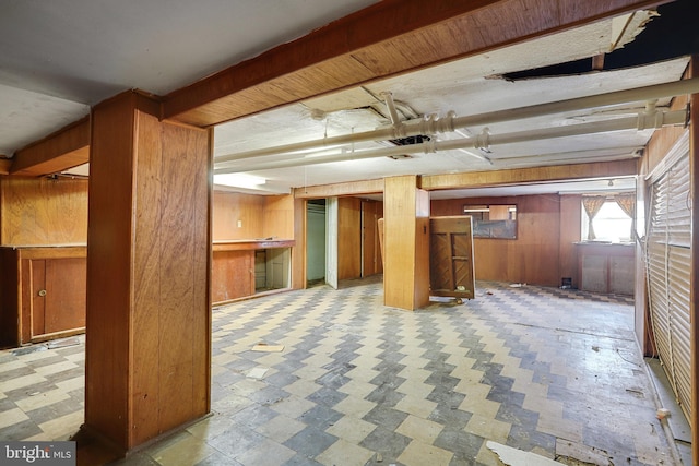 basement featuring wood walls