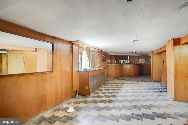 kitchen with kitchen peninsula and wood walls