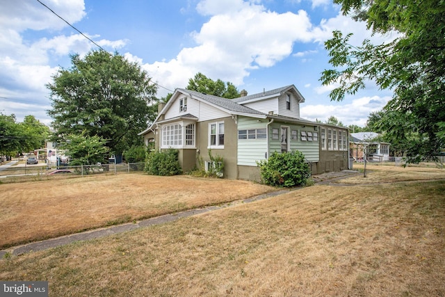 view of side of property with a lawn