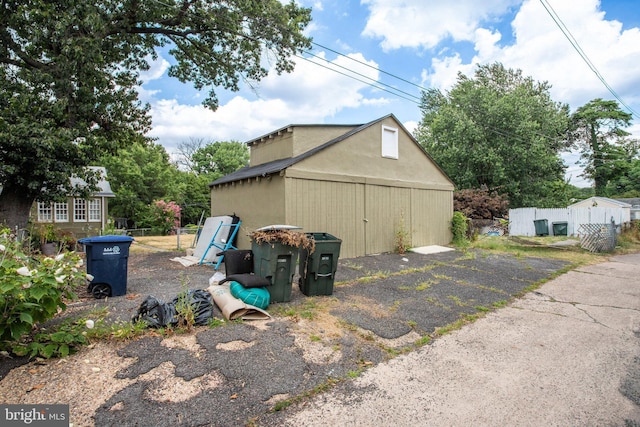 view of home's exterior featuring an outbuilding