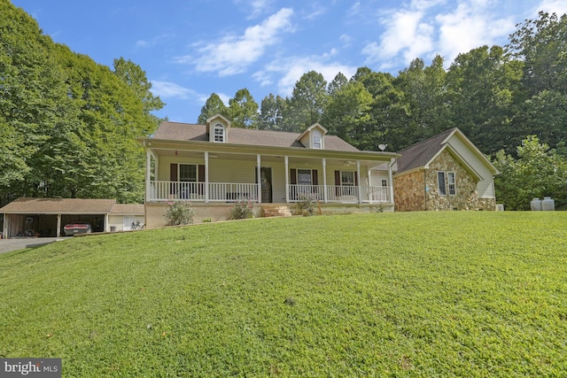 view of front of house with a carport, covered porch, and a front lawn