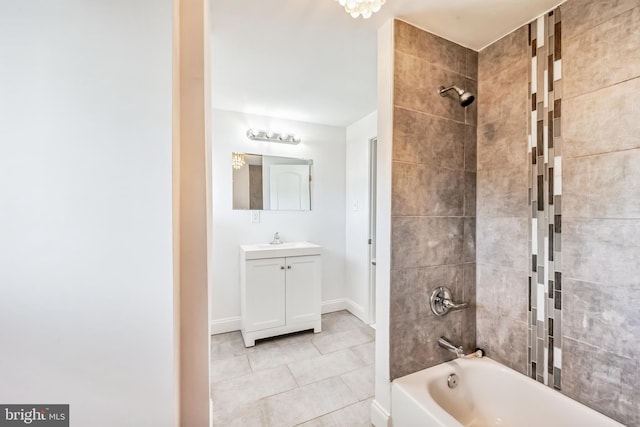 bathroom featuring tiled shower / bath combo, vanity, and tile patterned flooring