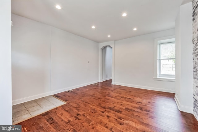 spare room with dark wood-type flooring