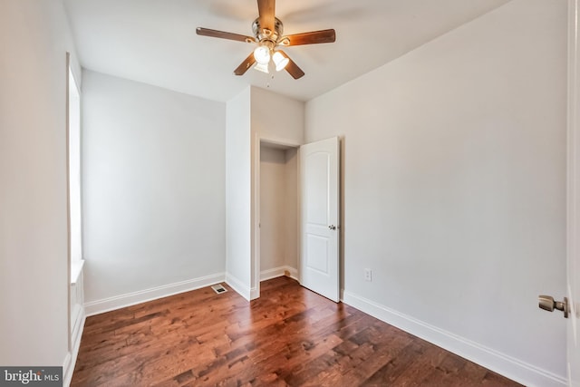 unfurnished bedroom with dark hardwood / wood-style floors and ceiling fan