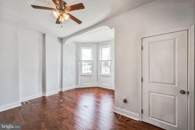 empty room featuring ceiling fan and dark hardwood / wood-style flooring