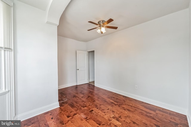 unfurnished room with dark hardwood / wood-style flooring and ceiling fan