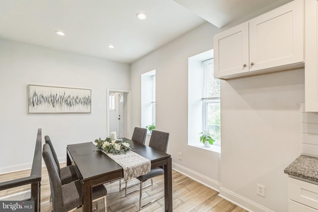 dining space with light hardwood / wood-style floors