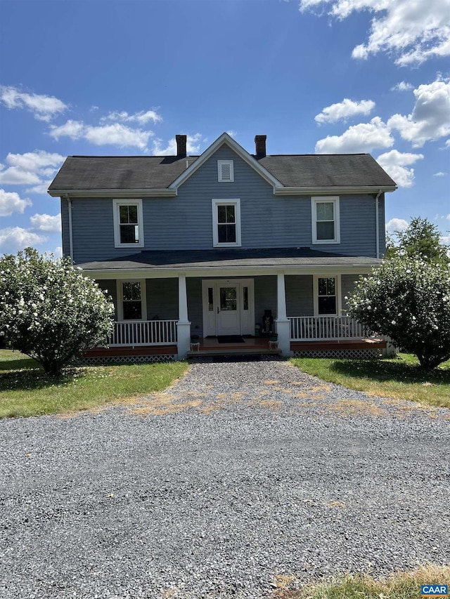 farmhouse-style home featuring covered porch