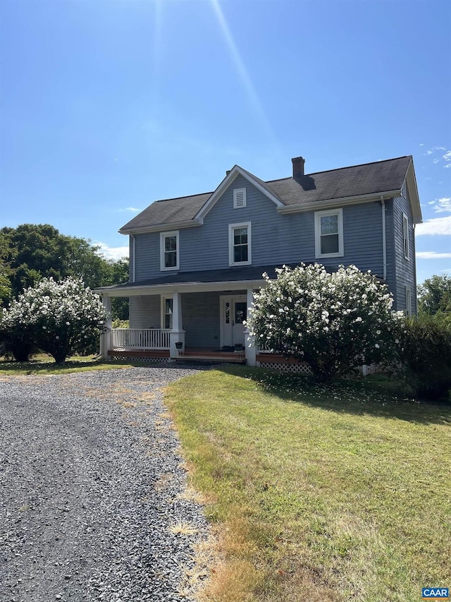 view of front of home with a front lawn and a porch