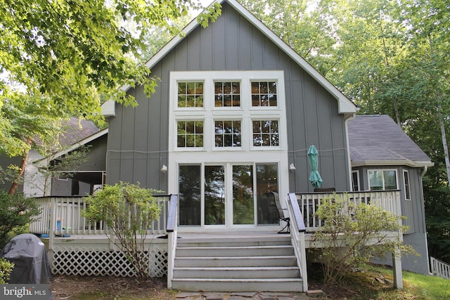 rear view of house featuring a wooden deck