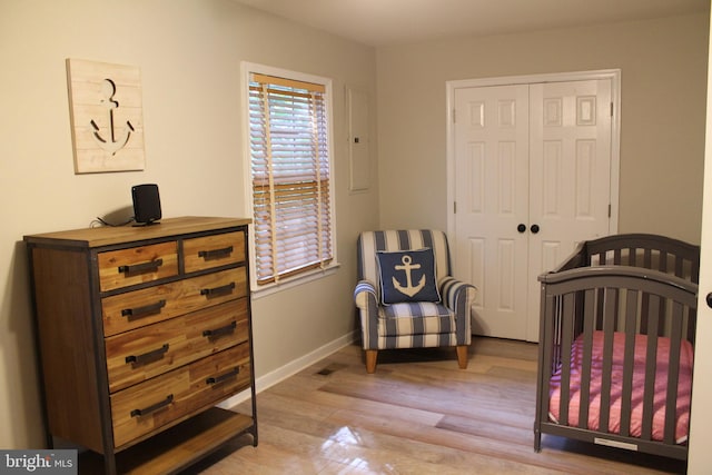 bedroom with light wood-type flooring and a closet