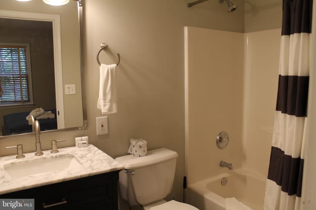 full bathroom with vanity, shower / tub combo, and toilet