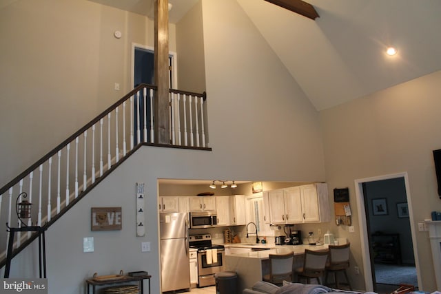 interior space with sink and high vaulted ceiling