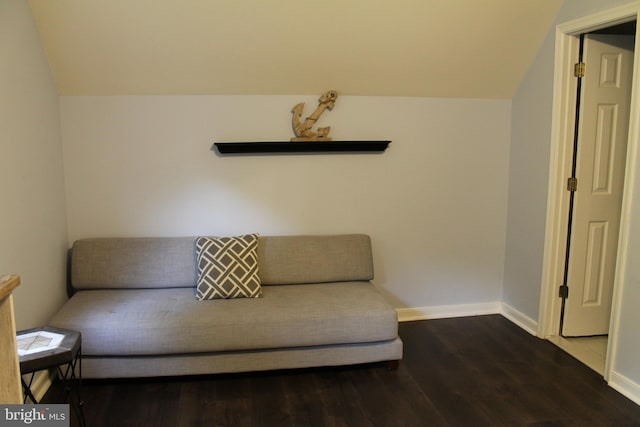 unfurnished room with hardwood / wood-style flooring and lofted ceiling