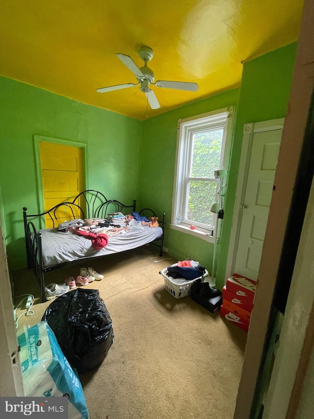 carpeted bedroom featuring ceiling fan