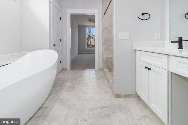 bathroom featuring a washtub and vanity