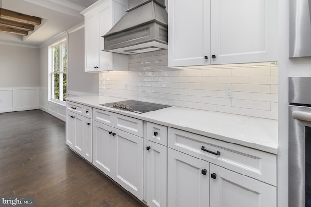 kitchen with white cabinetry, stainless steel oven, dark wood-type flooring, custom range hood, and black electric cooktop