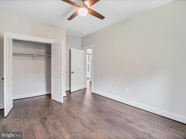 unfurnished bedroom featuring ceiling fan, a closet, and dark hardwood / wood-style flooring