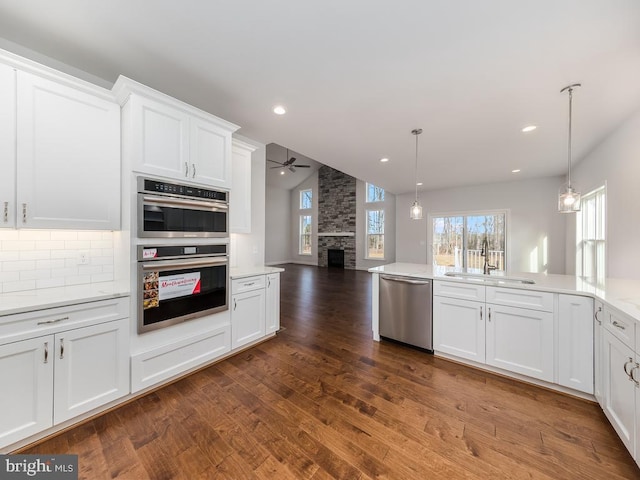 kitchen with ceiling fan, sink, white cabinets, and stainless steel appliances