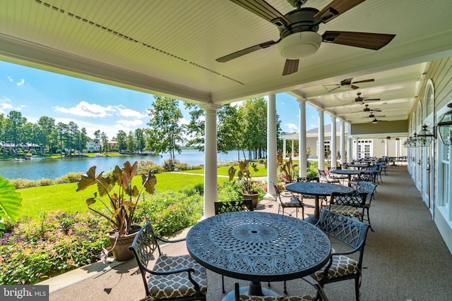 view of patio / terrace with ceiling fan and a water view