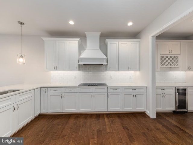 kitchen featuring premium range hood, white cabinetry, dark wood-type flooring, wine cooler, and hanging light fixtures