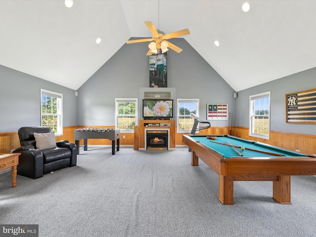 recreation room with ceiling fan, wooden walls, carpet flooring, high vaulted ceiling, and pool table