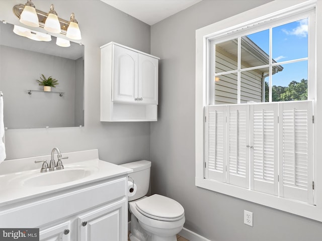 bathroom featuring toilet and vanity