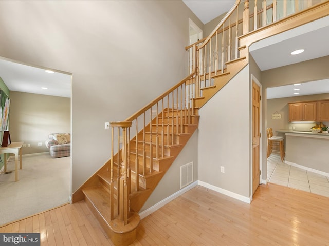 stairs featuring wood-type flooring