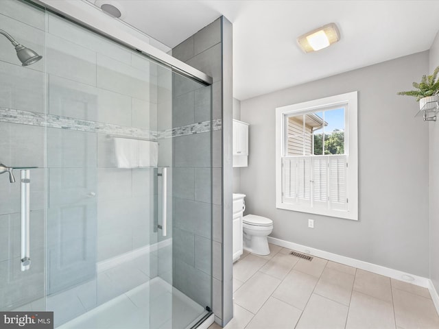 bathroom featuring toilet and a shower with door