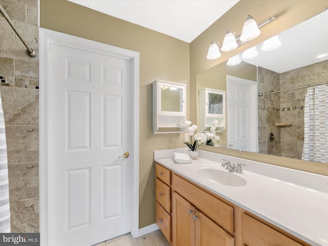 bathroom featuring tile patterned flooring, a shower with curtain, vanity, and a notable chandelier