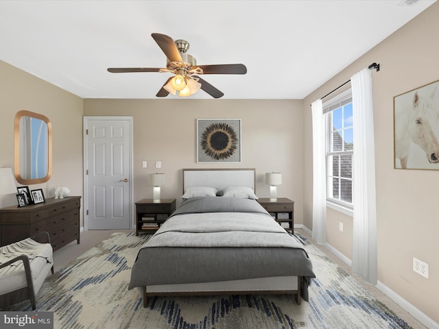 bedroom with ceiling fan and light colored carpet