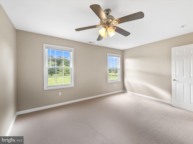 spare room featuring ceiling fan and carpet flooring