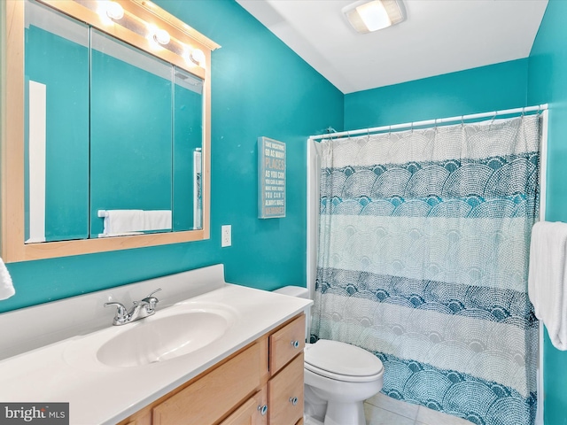 bathroom featuring toilet, vanity, walk in shower, and tile patterned flooring