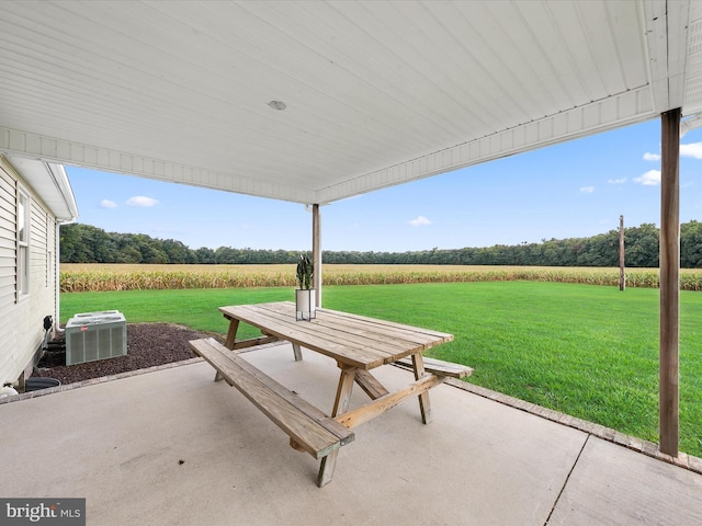 view of patio / terrace featuring central air condition unit and a rural view