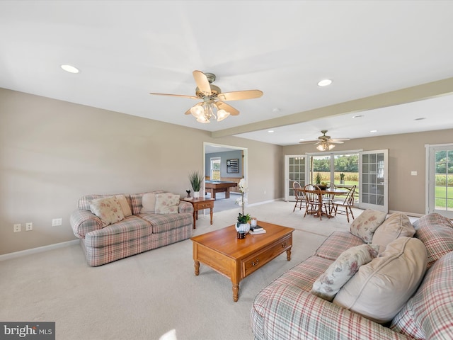 living room with ceiling fan and light colored carpet