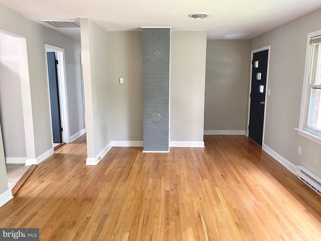 interior space featuring light wood-type flooring and a baseboard heating unit