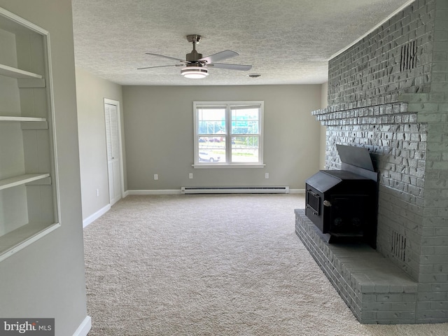 living room with ceiling fan, a wood stove, baseboard heating, a textured ceiling, and built in shelves