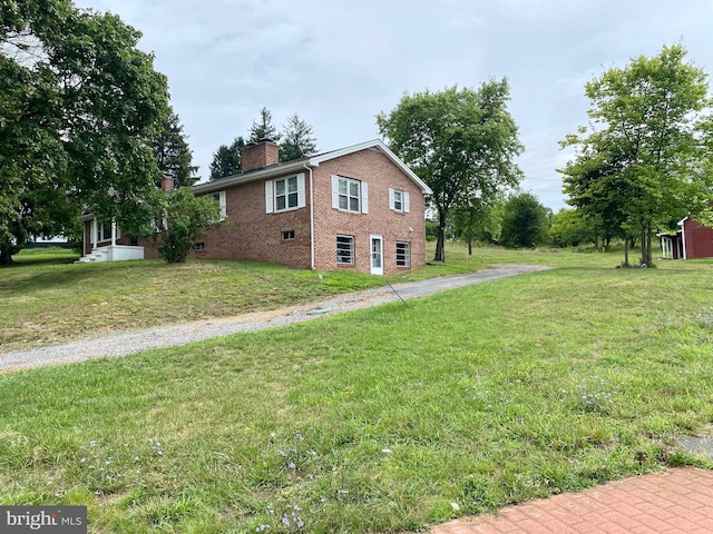 view of property exterior featuring a lawn