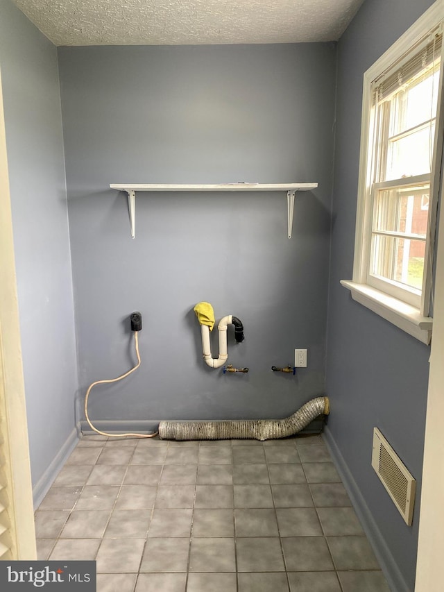 laundry area with a textured ceiling