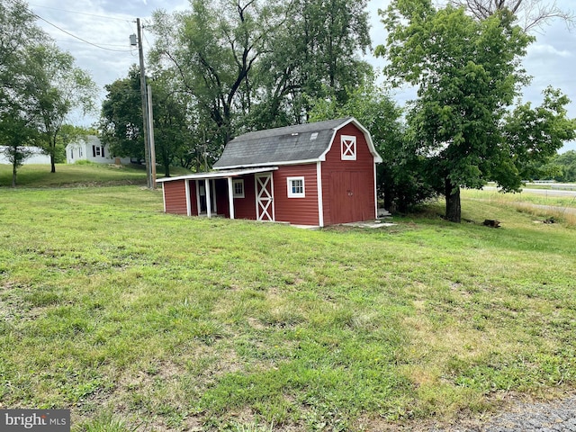 view of outbuilding featuring a yard