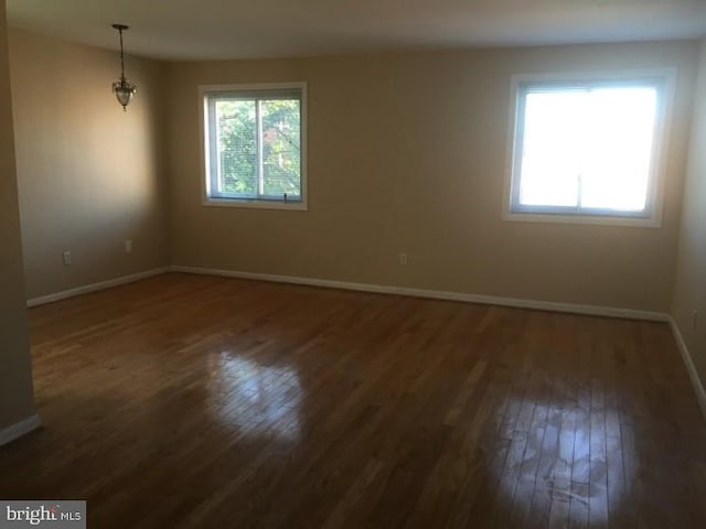 unfurnished room featuring dark hardwood / wood-style floors