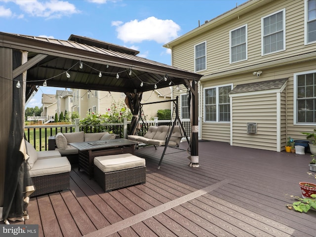 wooden deck featuring a gazebo and an outdoor hangout area