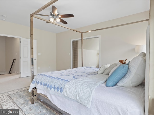 carpeted bedroom featuring a closet and ceiling fan