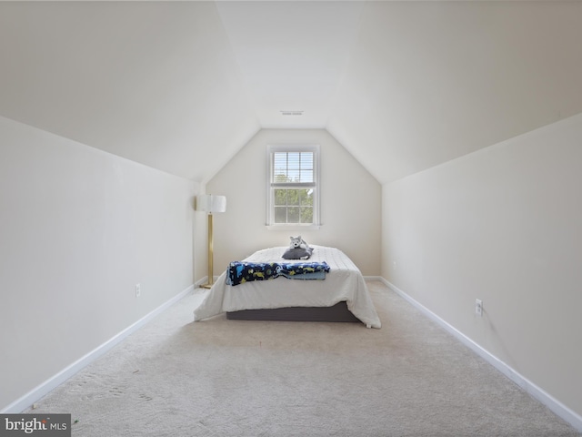 carpeted bedroom featuring vaulted ceiling