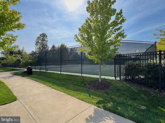 view of sport court featuring a yard