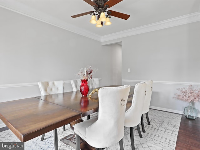 dining space with hardwood / wood-style floors, ornamental molding, and ceiling fan