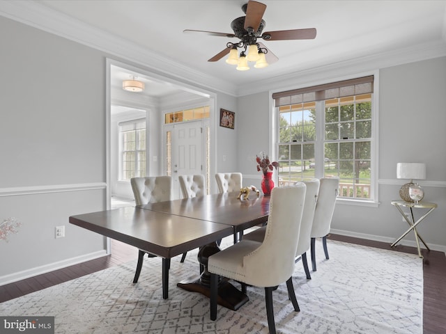 dining room featuring ornamental molding and dark wood-type flooring