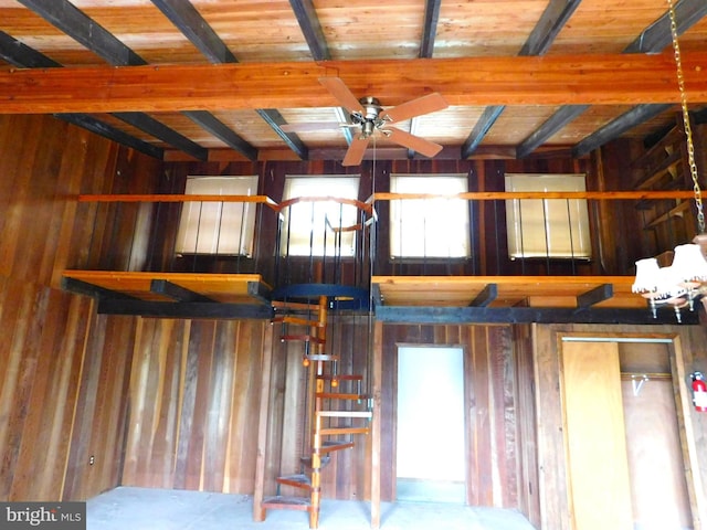 interior space featuring wooden ceiling, beam ceiling, and ceiling fan