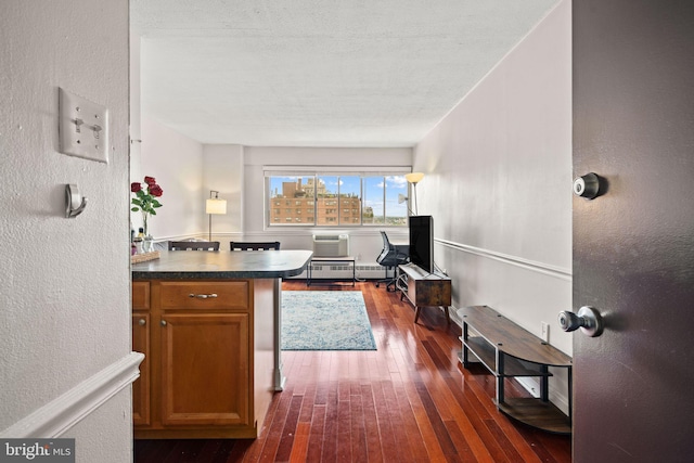 kitchen with a wall unit AC and dark hardwood / wood-style flooring